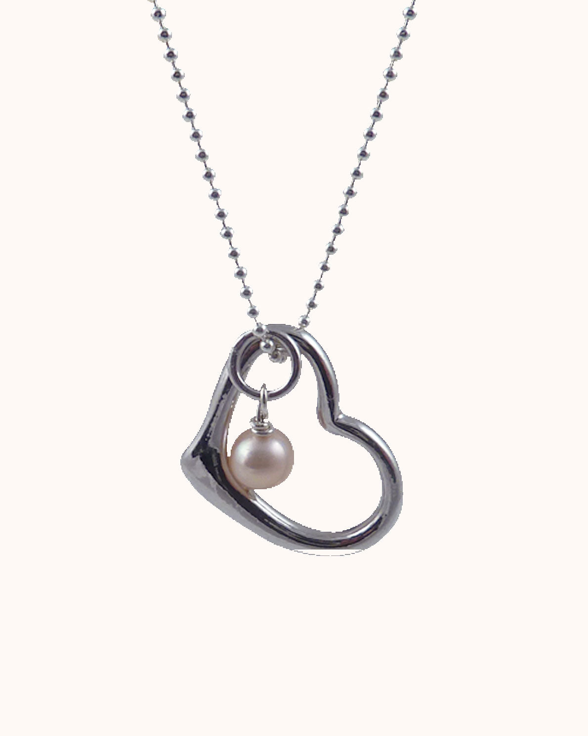 Modern pearl jewelry for Valentine's Day.  Delicate pearl pendant designed and created by Jewelry Olga Montreal Canada