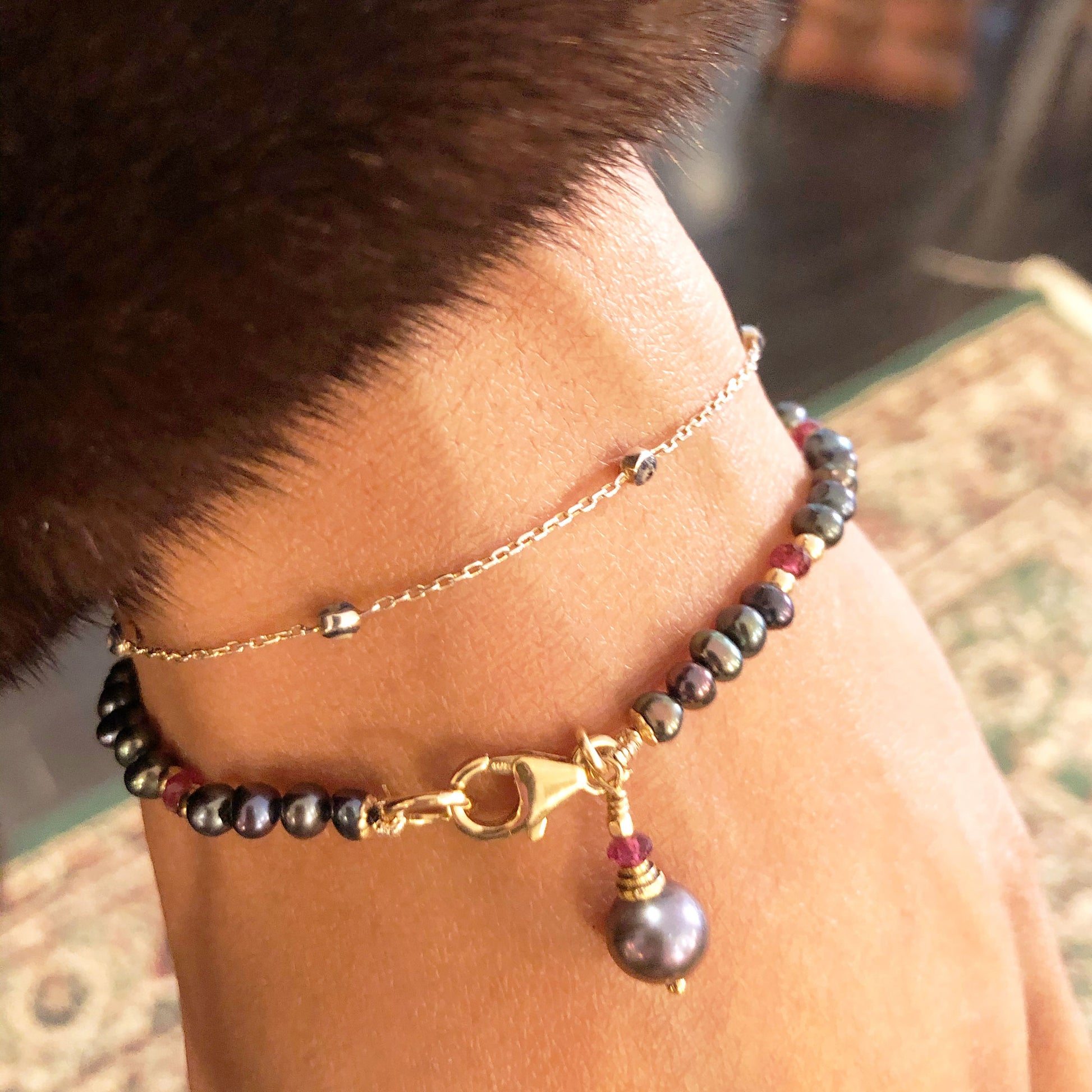 Dainty black pearl bracelet with pearl charm features small freshwater black pearls paired with wine-red garnet. Black pearl bracelet is a luxurious fashion accessory