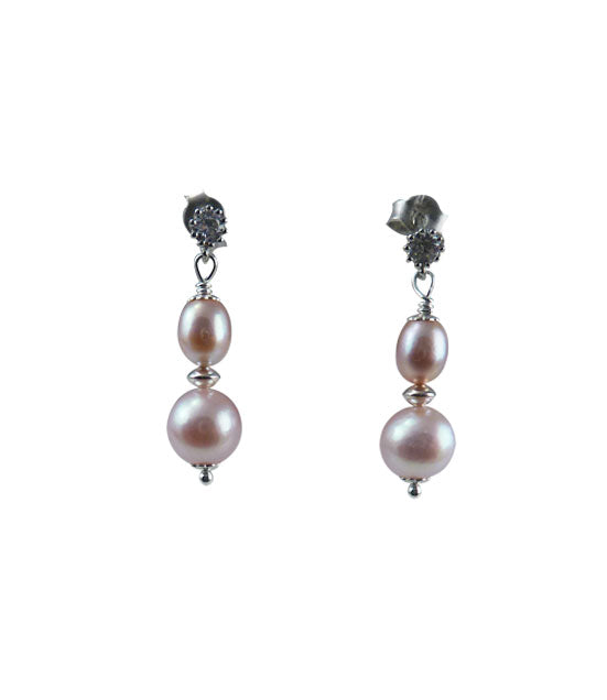 Dainty dangling pink pearl earrings featuring freshwater pink pearls
