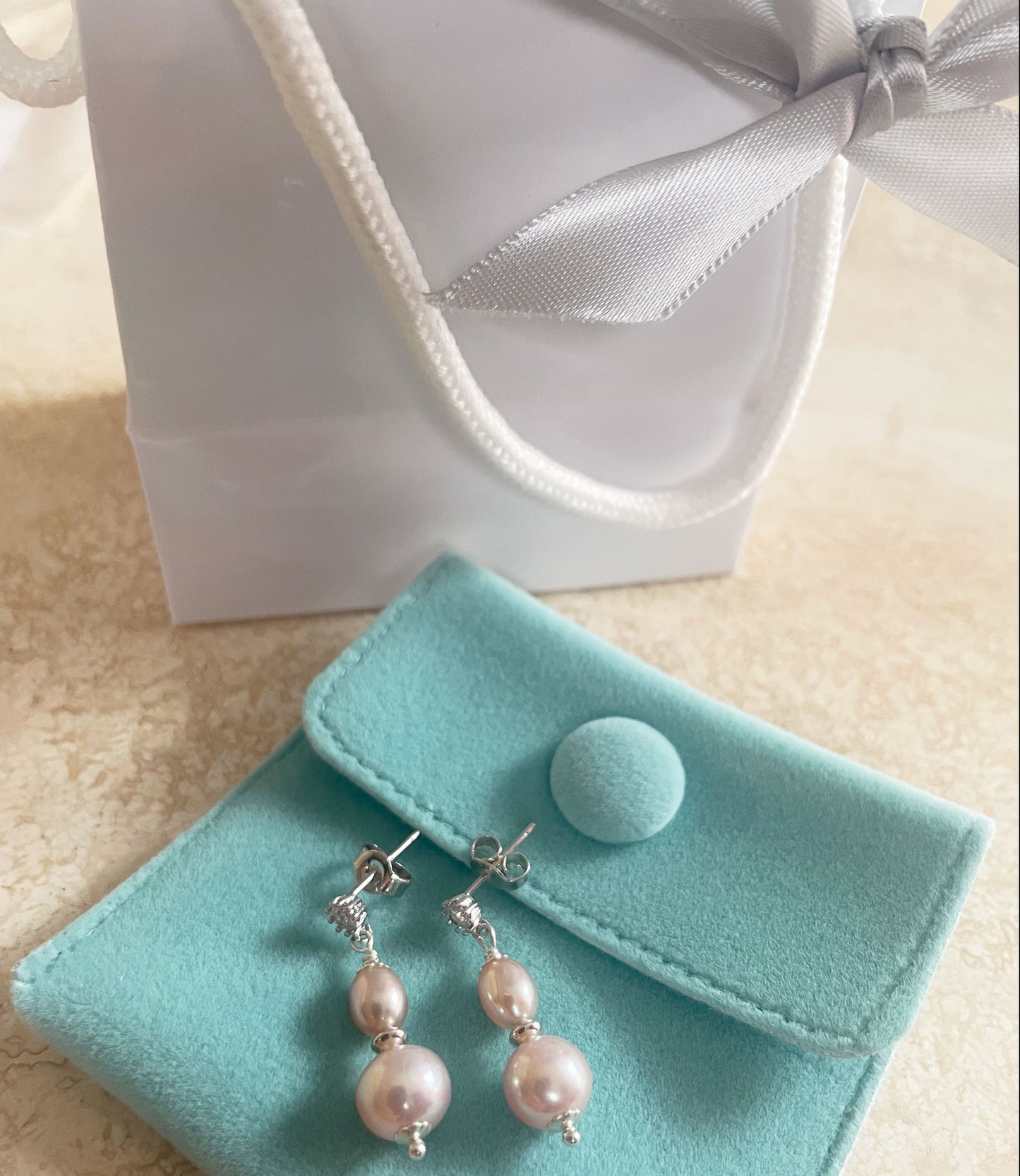 Dainty dangling pink pearl earrings are popular fashion-forward accessory.  You may wear this elegant modern pearl jewelry on any occasion