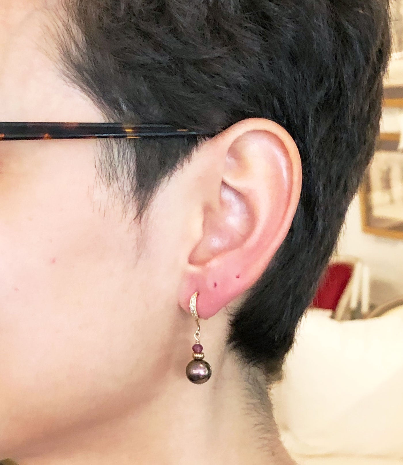 Dangling black pearl earrings with garnet may be worn on any occasion.  Custom black pearl jewelry is a great fashion accessory