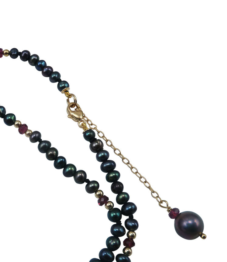 Delicate black pearl necklace with garnet is a stylish fashion accessory that will finish your look.  Contemporary pearl jewelry for fashion-forward women
