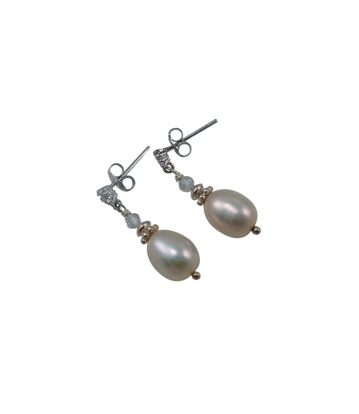 Delicate dangling pearl earrings featuring real pink pearls.  Contemporary pearl jewelry is a great holiday gift