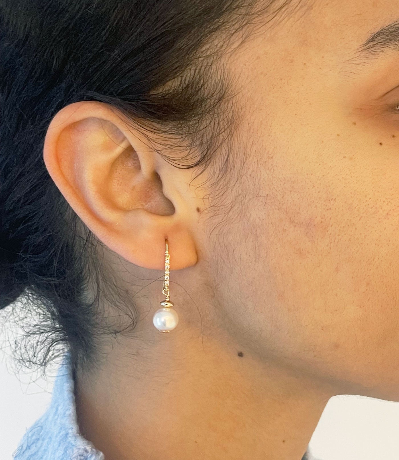 Golden dangling pearl earrings will finish any stylish look