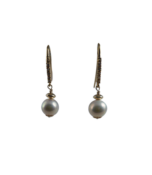 Golden dangling pearl earrings feature freshwater pearls.