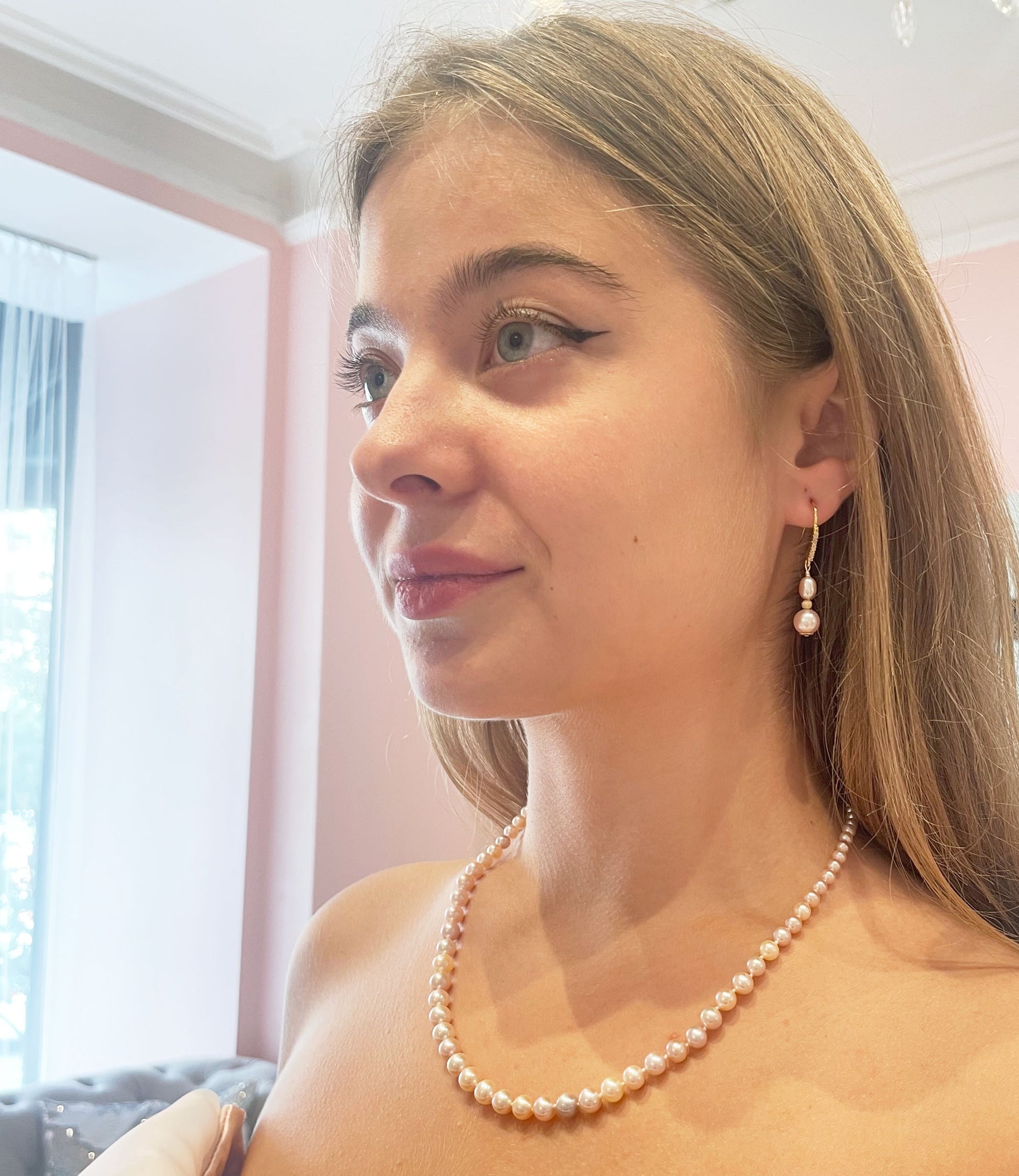 Long dangling pearl earrings feature gorgeous freshwater pink pearls.  You may wear these stylish custom pearl earrings from morning to night