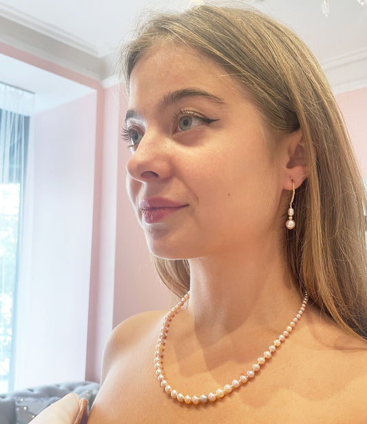Long dangling pearl earrings feature gorgeous freshwater pink pearls.  You may wear these stylish custom pearl earrings from morning to night