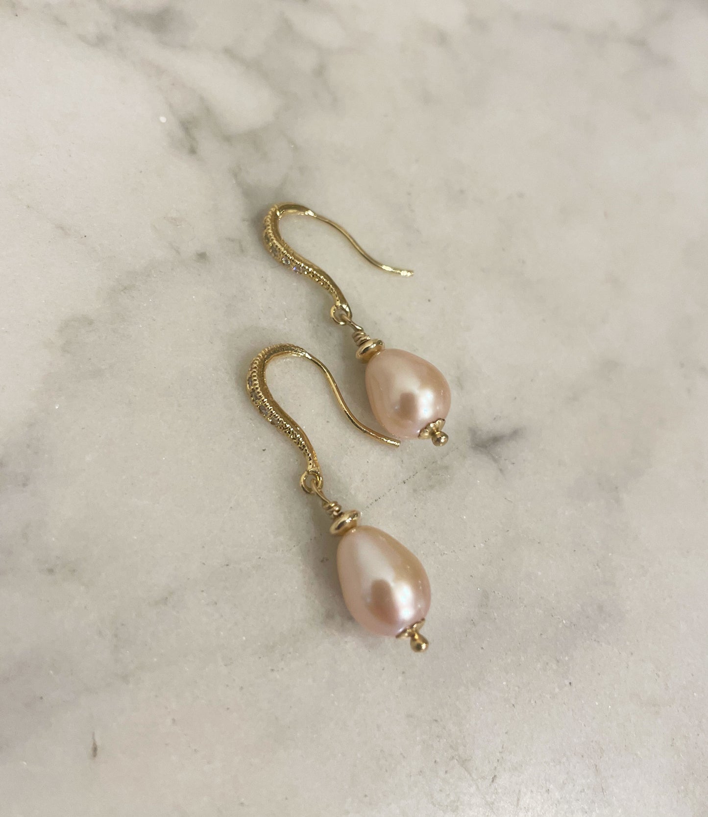 Contemporary dangling pearl earrings.  Highly lustrous genuine pink drop-shaped pearls
