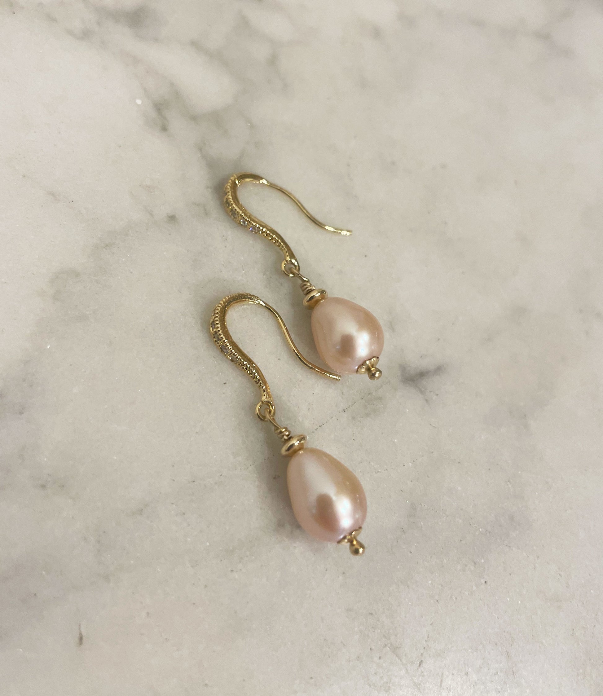 Contemporary dangling pearl earrings.  Highly lustrous genuine pink drop-shaped pearls