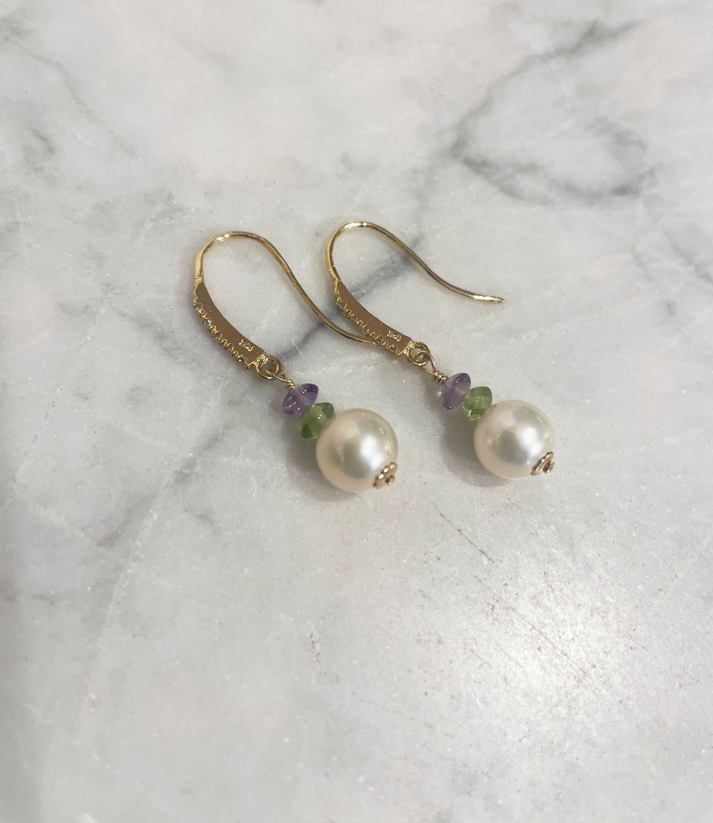 Long white pearl earrings feature highly lustrous white pearls paired with colored gems - peridot and amethyst