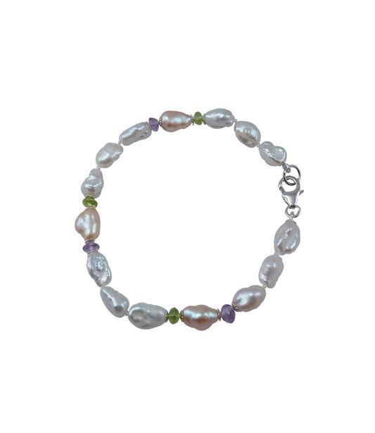 Modern keshi pearl bracelet featuring freshwater keshi pearls paired with colored gems.  Custom pearl jewelry