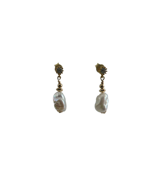 Modern white pearl earrings featuring lustrous freshwater keshi pearls. Contemporary pearl jewelry for everyday wearing or graduation gift.